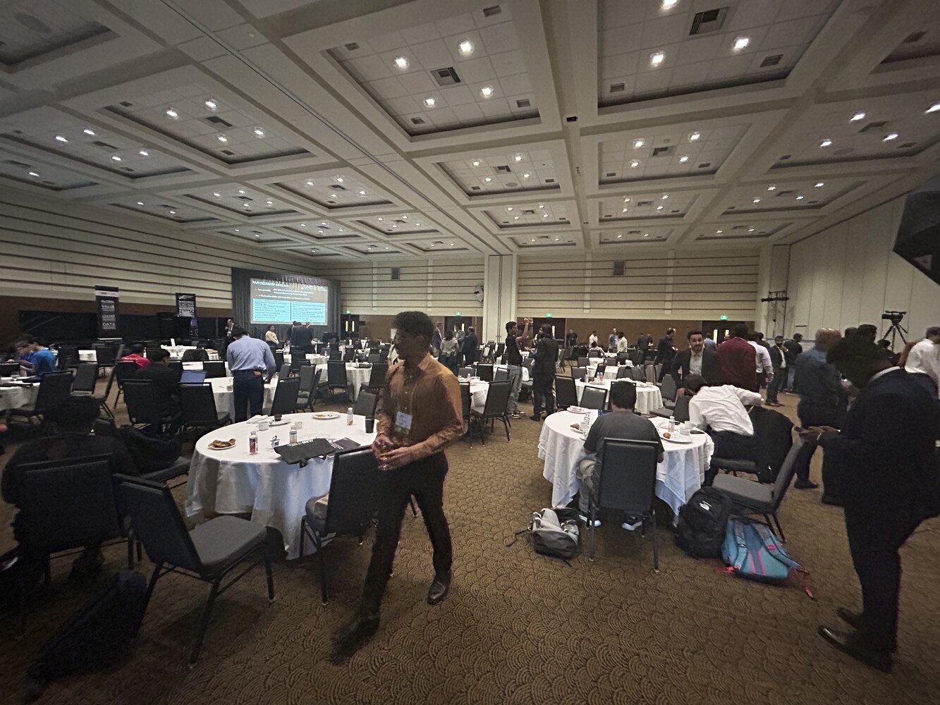 A wide-angle view of attendees networking and connecting at the 2025 Privacy, Security and Trust Industry Summit, held at the Fredericton Convention Center.