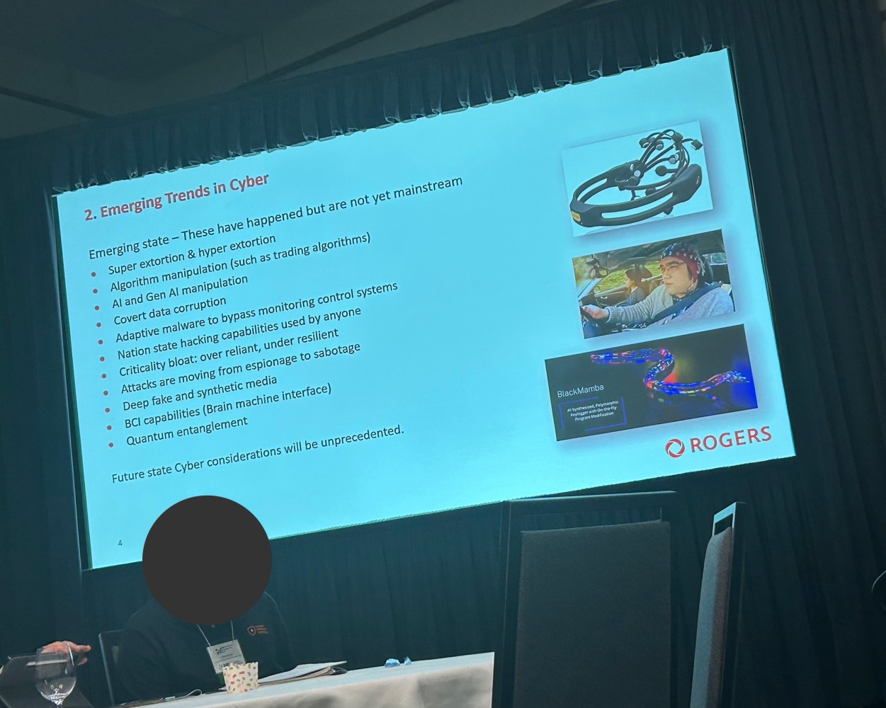 A slide from Paul Hanley's presentation on Emerging Trends in Cyber, highlighting critical issues such as AI manipulation, covert data corruption, adaptive malware, deepfakes, and the rise of super- and hyper-extortion.
